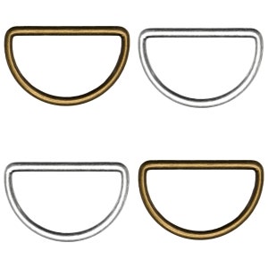 May include: Four D-rings, two in gold and two in silver. The D-rings are half-circle shaped and have a smooth finish.