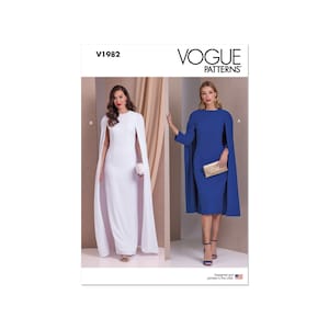 Op de afbeelding: Vogue Patterns naaipatroon V1982 voor een jurk met een cape. Het patroon toont twee versies van de jurk, een in wit en een in blauw. De jurk heeft een getailleerd bovenlijf en een vloeiende cape.