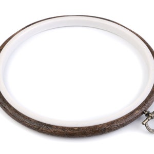 May include: A brown wooden embroidery hoop with a white inner ring and a metal clasp.