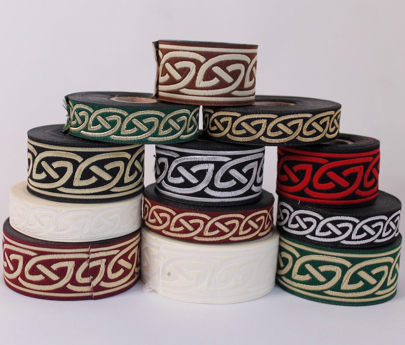May include: Assortment of eight spools of trim with a Celtic knot design. The trim is in various colors including brown, green, black, red, silver, and white.