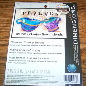 May include: Cross-stitch kit featuring two mugs with steam, the word "FRIENDS", and the phrase "so much cheaper than a shrink." Includes pre-sorted cotton thread, fabric, needle, and instructions. The package measures 7 x 5 inches.