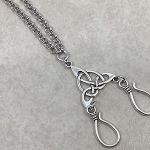 May include: Silver chain necklace with a Celtic knot pendant and two silver hooks.