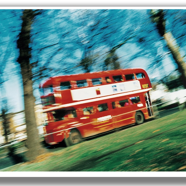 Old Routemaster London Bus (route 35), travelling across Clapham Common in London, with motion blur.