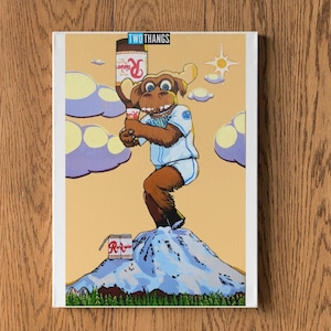 May include: A canvas print featuring a cartoon moose in a baseball uniform holding a can of soda, standing on a snowy mountain. The print has the text "TWO THANGS" at the top.