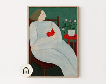 Peut inclure: Une impression d'art encadrée représentant une personne aux cheveux bruns vêtue d'un vêtement bleu clair à manches longues, assise sur une chaise marron foncé tout en lisant un livre rouge vif. À côté se trouve une petite table rouge avec un pot blanc.
