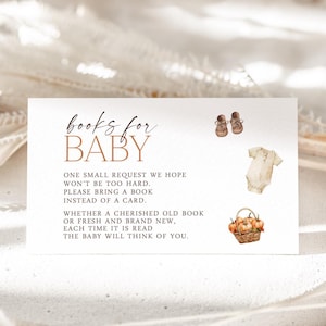 May include: A white card with the text "books for BABY" and a request to bring a book instead of a card. The card features illustrations of baby shoes, a onesie, and a basket of pumpkins.