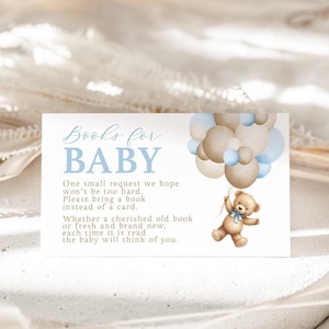 May include: A blue and white card with the text "Books for Baby" and a teddy bear holding balloons. The card says "One small request we hope won't be too hard. Please bring a book instead of a card. Whether a cherished old book or fresh and brand new, each time it is read the baby will think of you."