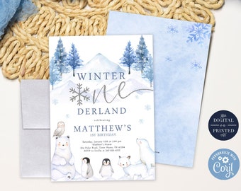 May include: A blue and white winter wonderland themed first birthday party invitation with a watercolor illustration of a snowy mountain, pine trees, and polar bears. The text reads "Winter One Derland celebrating Matthew's 1st Birthday".