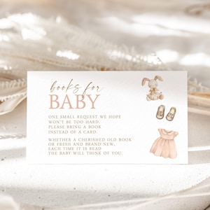 May include: A pink and white card with the text "books for BABY" and a request to bring a book instead of a card for the baby. The card features illustrations of a bunny, shoes, and a dress.