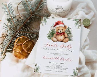 May include: A rectangular baby shower invitation card featuring a watercolor teddy bear wearing a red Santa hat and bow tie, surrounded by pine branches. The text reads: Santa Baby, MAX IS ON HIS WAY!, PLEASE JOIN US FOR A BABY SHOWER HONORING, Annabell Parker, SAT | 15 | DEC, 3:00 PM, PARKER RESIDENCE, 1234 BEAR DRIVE, ORLANDO, FL 12345, RSVP ANN 123.456.7890 BY 12/5, REGISTERED AT BABYREGISTRY.COM.