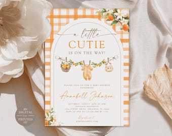 May include: A rectangular baby shower invitation featuring an orange and white gingham background. The text reads A LITTLE CUTIE IS ON THE WAY! with illustrations of a basket of oranges, a baby onesie, and a bib hanging on a clothesline.