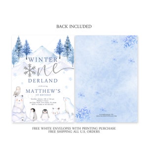 May include: A first birthday invitation with a winter wonderland theme. The invitation is blue and white and features a snowy mountain scene with a polar bear, penguins, and a fox. The text on the invitation reads "Winter One Derland celebrating Matthew's 1st Birthday".