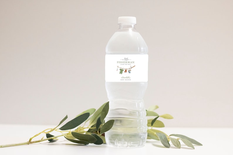 May include: A clear plastic water bottle with a white label featuring the text "Little Fisherman is on the Way" and baby-themed illustrations. The label also includes the name "Annabelle's Baby Shower".