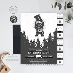 May include: A baby shower invitation with a black and white design featuring a silhouette of a bear with the text "A Baby Boy is on the Way!"  The invitation is for Kayla Robinson and includes the date, time, and location of the shower.  The invitation also includes the text "Registered at Target".
