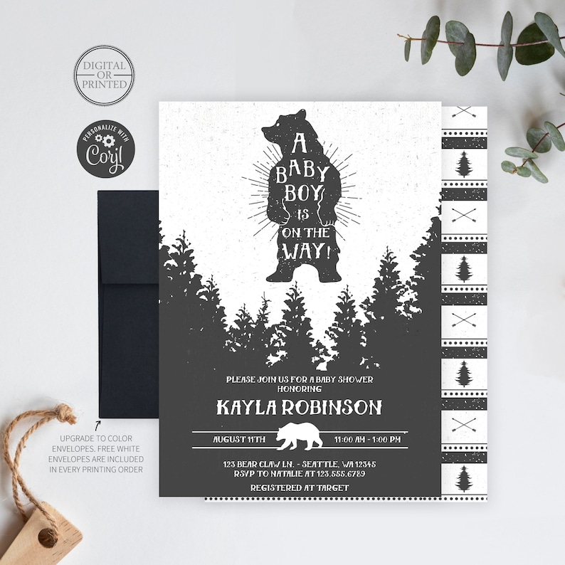 May include: A baby shower invitation with a black and white design featuring a silhouette of a bear with the text "A Baby Boy is on the Way!"  The invitation is for Kayla Robinson and includes the date, time, and location of the shower.  The invitation also includes the text "Registered at Target".