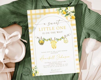 May include: A rectangular baby shower invitation card featuring a yellow and white chequered border, lemon illustrations, and the text A sweet little one is on the way! The card includes details for Annabell Johnson on August 15th at 3 PM.