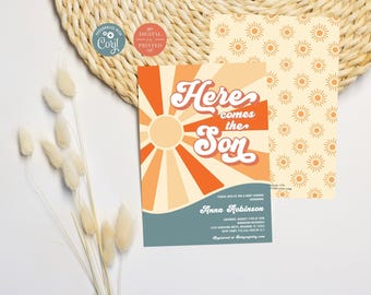 May include: A rectangular baby shower invitation card featuring a sun graphic with orange and cream rays, the text Here comes the Son, and event details for Anna Robinson. The card has a blue bottom section and a matching sun-patterned back.
