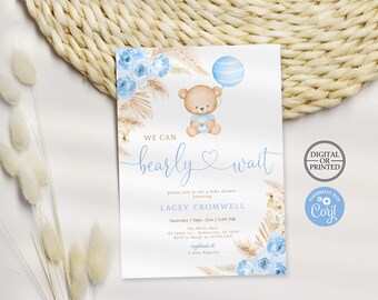 May include: A rectangular baby shower invitation card featuring a brown teddy bear holding a blue balloon, blue floral accents, and dried pampas grass. The text reads WE CAN bearly WAIT, honoring Lacey Cromwell on Saturday, Sept. 21st at 3:00 PM.