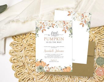 May include: A rectangular baby shower invitation card featuring watercolor illustrations of orange and white pumpkins, autumn leaves, and white flowers. The text reads A LITTLE PUMPKIN IS ON THE WAY, Annabell Johnson, and event details.