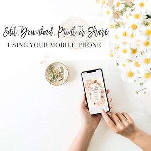 May include: A mobile phone displaying a digital invitation for a bridal shower. The invitation features a floral design with dried grasses and the text "Bridal Shower". The phone is being held by a person's hands on a white surface.