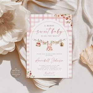 May include: A baby shower invitation card featuring a pink and white gingham background with an arched frame. The text reads A BERRY sweet baby IS ON THE WAY! and includes details for Annabell Johnson on Saturday, August 15th at 3PM.