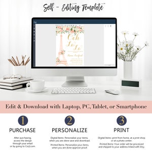 May include: A computer screen displaying a pink and gold Eiffel Tower themed invitation with the text "Ooh La La" and "Renee Lurferd". The screen is on a white desk with a cup of coffee, a keyboard, and a mouse. The text below the screen reads "Edit & Download with Laptop, PC, Tablet, or Smartphone". Below that are three steps: "1. Purchase", "2. Personalize", and "3. Print".