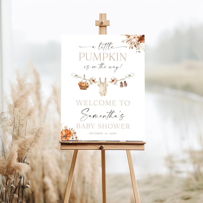 May include: A white baby shower sign on a wooden easel, with the text "a little PUMPKIN is on the way!" in elegant script. The sign includes a basket, baby clothes, and baby shoes. The words "WELCOME TO Samantha's BABY SHOWER" are also displayed.