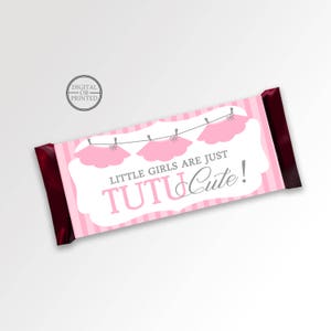 May include: Pink and white striped candy bar wrapper with a pink tutu and the text "Little girls are just tutu cute!"