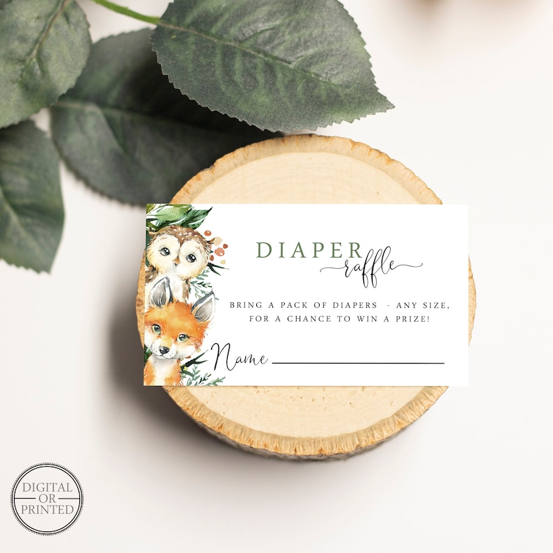 May include: A white card with a green and brown woodland animal illustration. The card says "DIAPER raffle" and "BRING A PACK OF DIAPERS - ANY SIZE. FOR A CHANCE TO WIN A PRIZE!" with a blank line for a name.