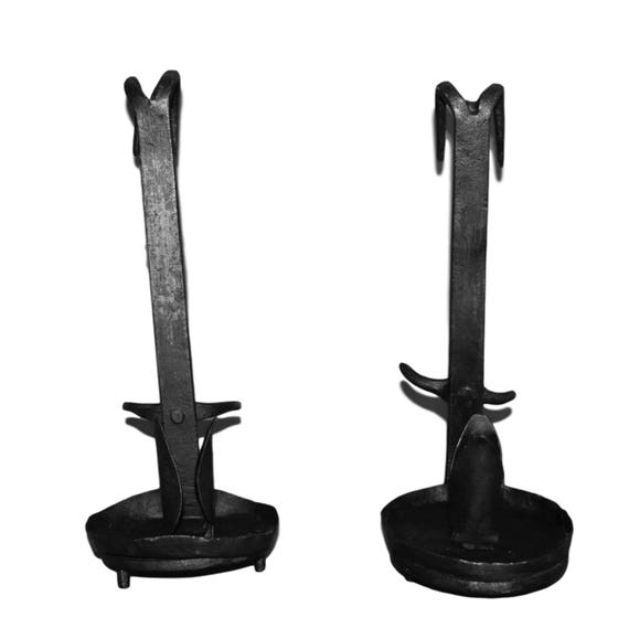 A pair of wrought iron Gothic candlesticks