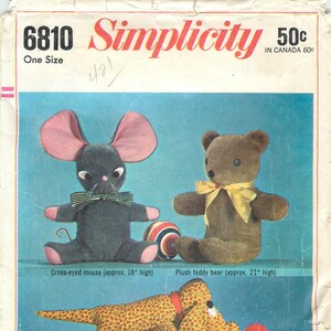 May include: Vintage Simplicity pattern featuring three cuddly stuffed toys: a cross-eyed mouse (approx. 18 inches high), a plush teddy bear (approx. 21 inches high), and a flop-eared dog (approx. 18 inches long). The pattern includes the text "Three Cuddly Stuffed Toys".