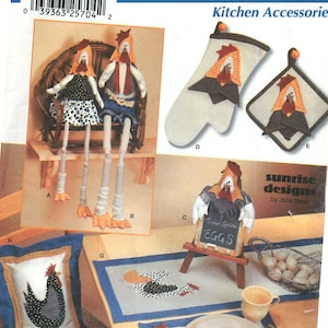 May include: A sewing pattern for a kitchen themed set of home decor items. The pattern includes instructions for making a pair of chicken dolls, a pot holder, a hot pad, a table runner, a placemat, a napkin ring, and a chalkboard sign. The pattern is titled "Sunrise Designs by Jana Beus".