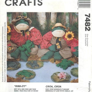 May include: A McCall's Crafts pattern featuring frog dolls. The dolls are 24 inches high and dressed in red and brown patterned outfits. The image includes the text "RIBB-ITT" and "CROA, CROA".