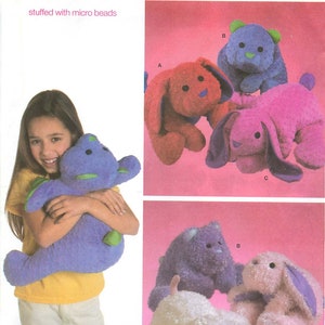 May include: Simplicity pattern 4591 for squeezable soft animal pillows stuffed with micro beads. The package features illustrations of various plush animals including rabbits and bears in purple, red, pink, and white with black eyes.