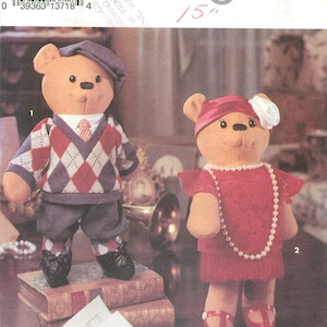 May include: Simplicity pattern 8265 for stuffed teddy bears. One bear wears a sweater, pants, and a hat. The other bear wears a red dress and a pearl necklace. The pattern is for a 15-inch bear.