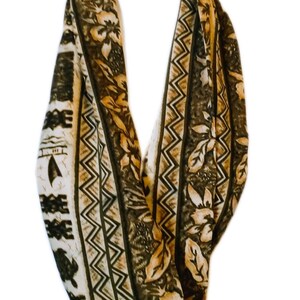 May include: A brown and beige patterned infinity scarf with a geometric design and floral print.