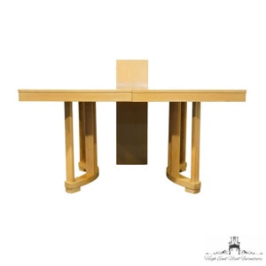 May include: A light wood dining table with a leaf extension. The table has a rectangular top and curved legs.