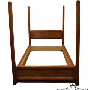 May include: A wooden bed frame with tall posts and a headboard. The frame is made of dark wood and has a simple design.