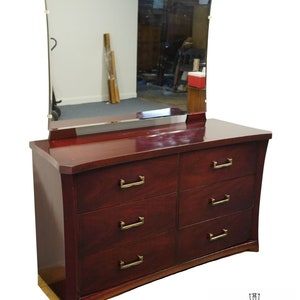 May include: A mahogany dresser with six drawers and a beveled mirror. The dresser has brass hardware and a curved front.
