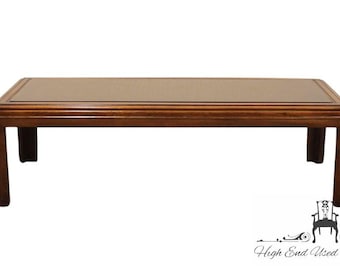 May include: A rectangular wooden coffee table with a dark brown finish. The table has a simple design with a flat top and four legs.