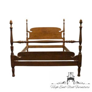 May include: A wooden four-poster bed frame with a medium brown finish. The bed features tall, turned posts with finial tops, a curved headboard, and a matching curved footboard. The side rails connect the posts, creating a sturdy structure.