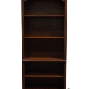 May include: A tall, dark brown wooden bookcase with an arched top and multiple shelves. The bookcase has a classic design and is suitable for storing books and displaying decorative items. The bottom of the bookcase has a solid base.