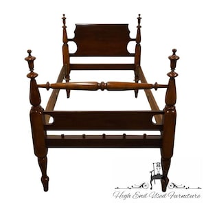 May include: A wooden bed frame with a headboard and footboard. The frame is made of dark wood and has a simple design. The bed frame is in good condition and would be a great addition to any bedroom.