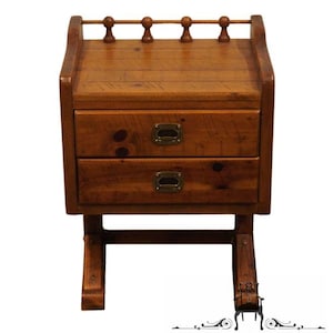 May include: A wooden end table with two drawers and a decorative top rail. The table has a rustic, distressed finish and is supported by two curved legs.