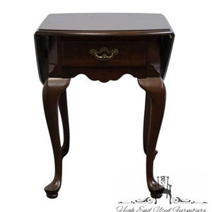 May include: A dark brown, antique side table with a single drawer and a brass handle. The table has a rectangular top with rounded corners and curved legs. The table is approximately 24 inches tall.