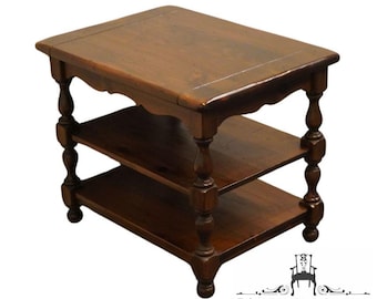 May include: A dark brown wooden end table with two shelves and turned legs. The table has a simple, traditional design.