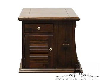 May include: A dark brown wooden nightstand with a drawer and a cabinet door with horizontal slats. The nightstand has a rounded top and a small, decorative handle on the side. The drawer and door have white knobs.