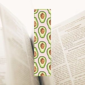 May include: A pink and green avocado bookmark with a repeating pattern of avocado halves.