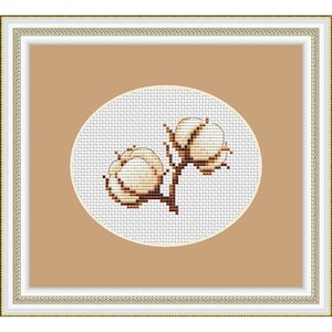 May include: A white cotton flower cross stitch pattern in a brown frame. The cotton flower is in a circle on a white background.