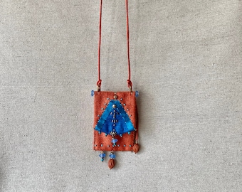 Long necklace with orange and turquoise blue silk pendant.